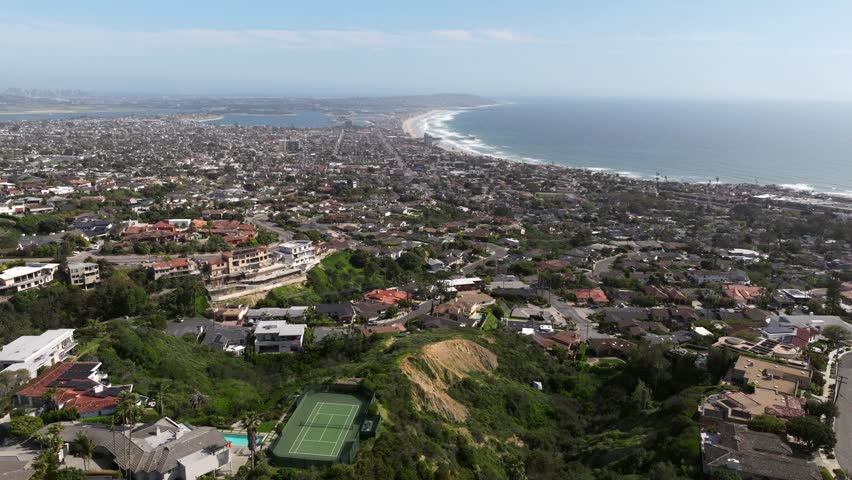 Aerial view over La Jolla Mesa San Diego with views of the Pacific Ocean Mission Bay and luxury homes on a sunny day in Southern California