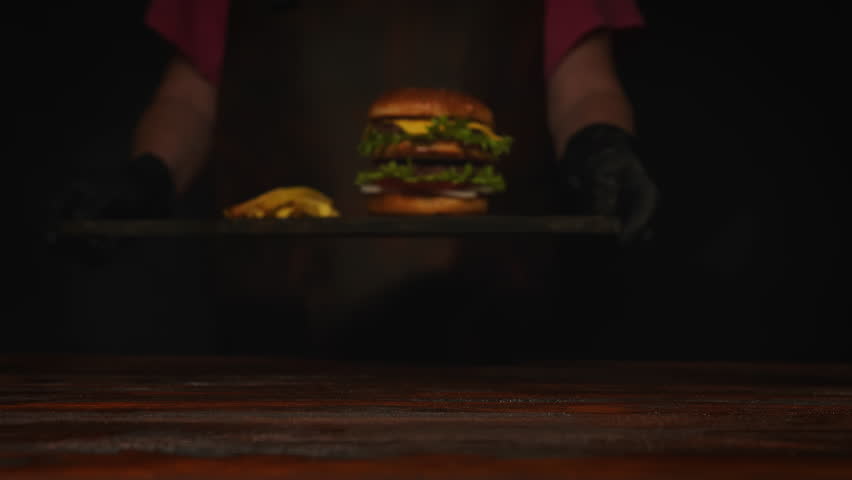 Burger with french fries serving in restaurant.