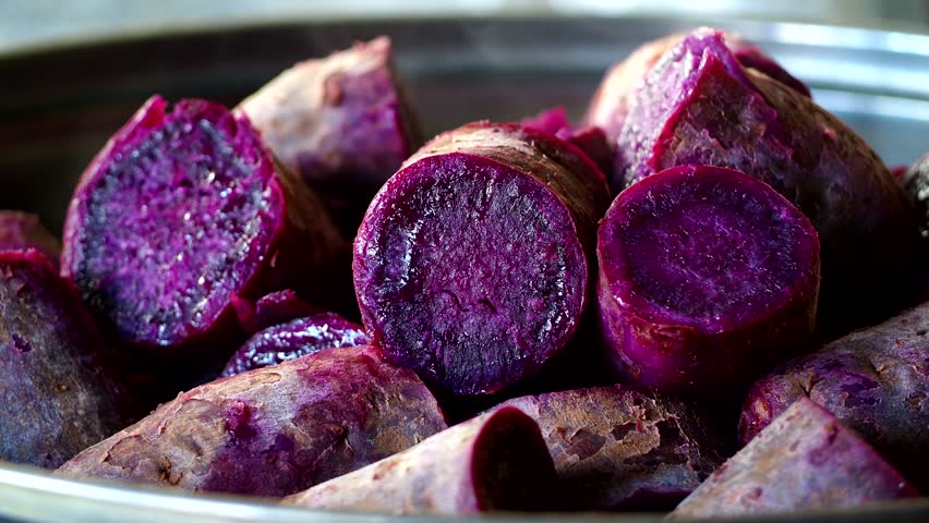 Steaming purple sweet potatoes in pot, in door  Chiangmai  Thailand.