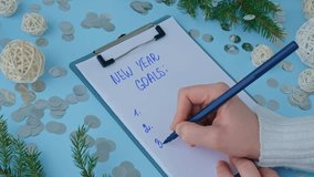 Handwritten new year resolutions aims goals on paper notepad. Preparation for New Year. Planning and setting goals for personal development  - Powered by Shutterstock - Get 15% off with code: PIKWIZARD15