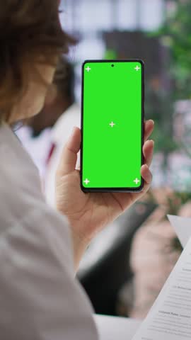 Vertical Video Recruiters team evaluating applicants resumes next to a green screen, looking at qualifications and work experience. HR experts selecting candidates to fill in a job vacancy at