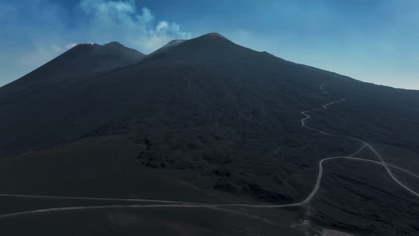 Strombolian activity from the Voragine on Etna. Explosions, lava. July 2024 Etna active on the summits. Sunset. Wells with gas emission. North East and South East Crater with Bocca Nuova.
