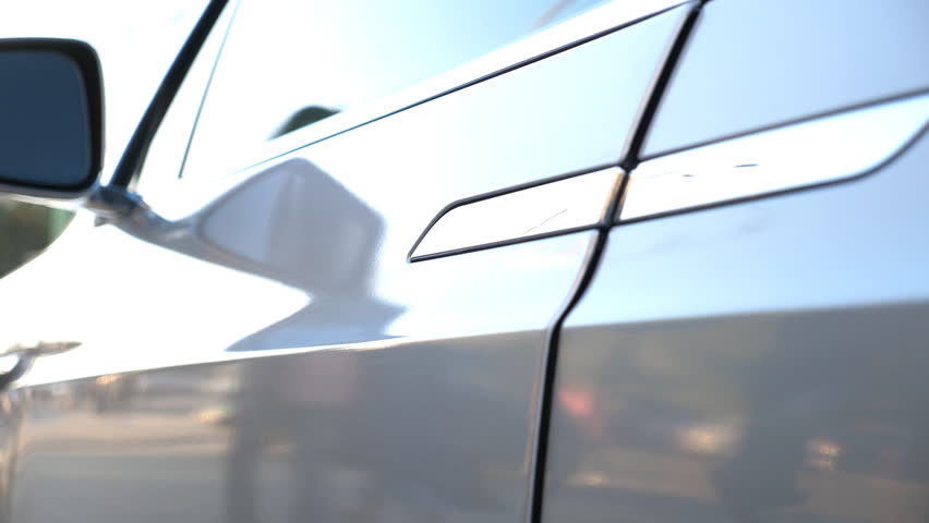 Man opening door and get out from modern car. Guy uncover door of automobile. Person exit from electrical auto. Commuter to job or deal. Concept of contemporary technologies. Close up Slow Motion