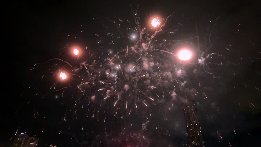 Spectacular Fireworks Celebrating New Year Eve, A vivid display of colorful real fireworks lighting up the night sky, celebrating New Year Eve with big, vibrant explosions during major festivals