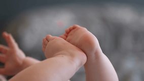 A peaceful newborn baby lies relaxed on a bed, with a close-up shot focusing on their tiny, adorable feet. The scene captures the innocence and tranquility of the infant, highlighting the delicate det - Powered by Shutterstock - Get 15% off with code: PIKWIZARD15