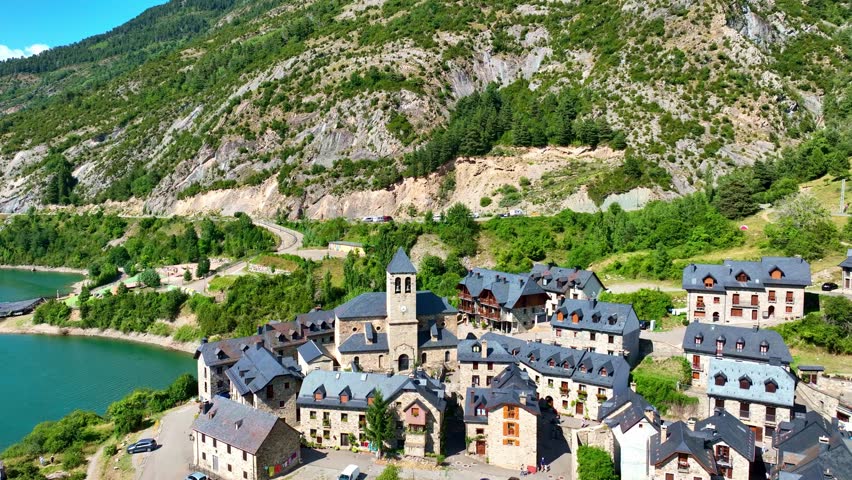 scenic lake in Spanish Pyrenees aerial view, summer in the Spanish Pyrenees, hiking in the Pyrenees in Spain, Lanuza medieval village in Spanish Pyrenees. High quality 4k footage