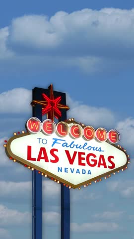 A daytime vertical shot of the Las Vegas welcome sign with a timelapse cloudscape behind.	