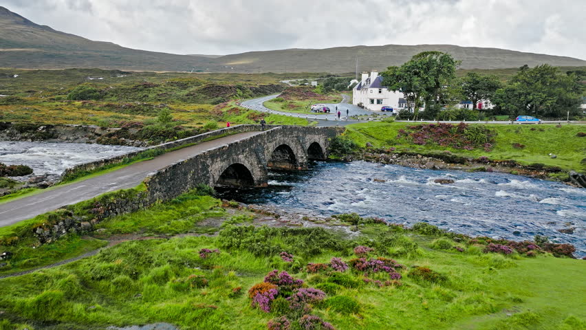 Aerial view of a curved old bridge, Tourist attraction in Scotland. Scottish Highlands Sligachan Old Bridge on the Isle of Skye.
