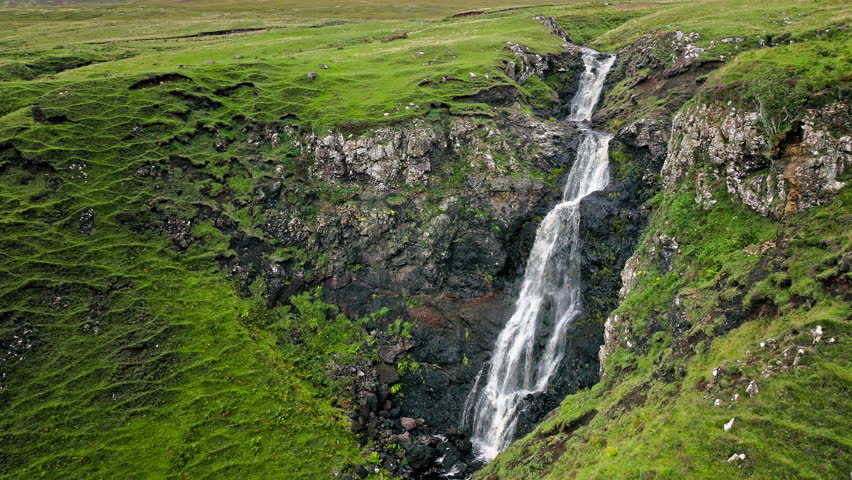 Aerial view of Scottish highlands falls in Scotland. Waterfall landscape in the United Kingdom. Scenic drone view of waterfalls on the Isle of Skye.