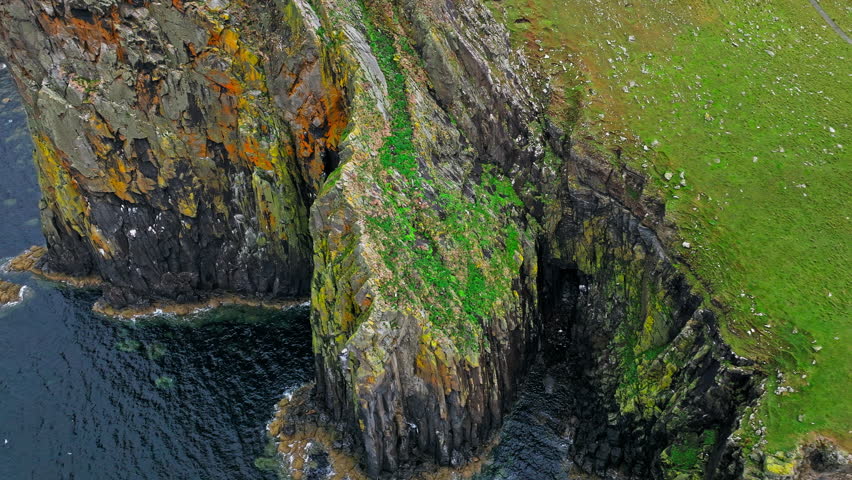 Dramatic rocky cliff on the coastline in Scotland, United Kingdom. Scottish Highlands.Travel destination. Tourist attraction landmark Neist Point Lighthouse on Isle of Skye.