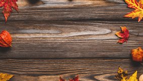 Autumn and thanksgiving background. Frame made of autumn leaves, flowers, pumpkin, nuts on rustic wooden background. Flat lay, top view - Powered by Shutterstock - Get 15% off with code: PIKWIZARD15