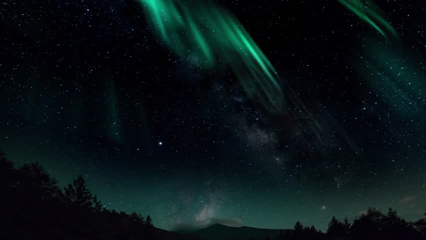 Aurora Borealis interweaving with the Milky Way Galaxy. Northern Lights Time Lapse Solar Wind. Dance of Celestial Lights. Northern Lights twirling with solar wind flaring in green and purple