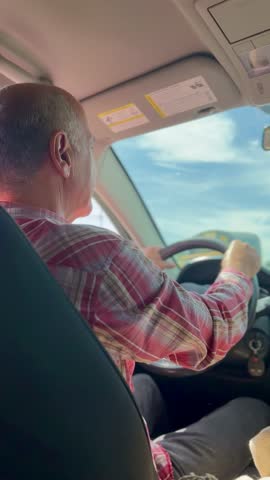 Latin father driving with his accompanying family to visit Colombian towns. Happy and smiling people. Travels.