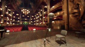 An empty stage set up with rows of chairs and a microphone at the center, awaiting a performance or presentation. - Powered by Shutterstock - Get 15% off with code: PIKWIZARD15