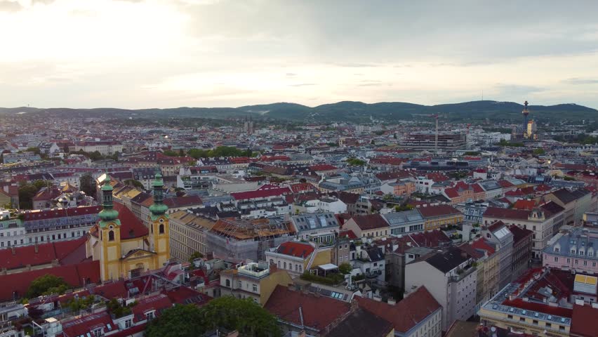 Vienna at sunset showcasing historic buildings and scenic rooftops, aerial view