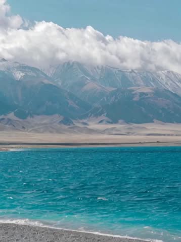 Breathtaking landscape with rolling hills and majestic mountains in the background.