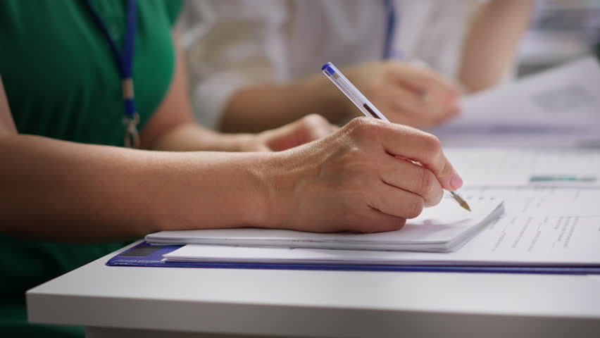 HR recruiters interviewing a job seeker and taking notes during meeting, attending an interview and conducting an evaluation. Headhunters and applicant in recruitment process. Close up. Camera A.