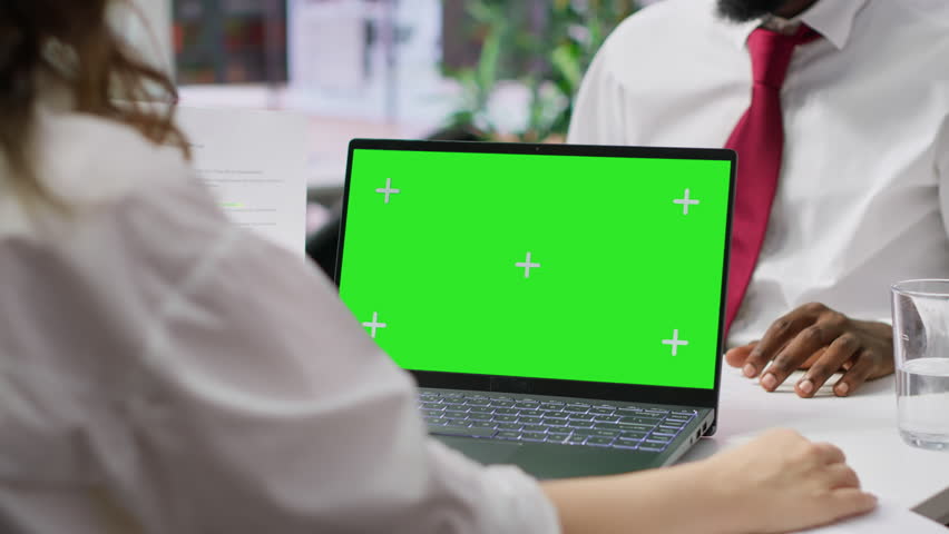 HR manager doing a job interview with candidate by using laptop with chroma key mockup, asking questions about his studies and qualifications. Businesswoman meeting with applicant. Camera A.