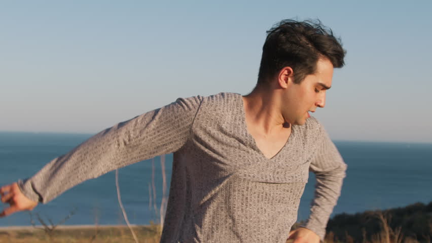 Boy Dances In Calabria To Latin American Music Near Ocean