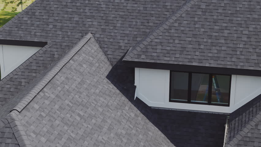 Drone footage of new roof is installed on a house. Day time