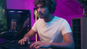 Indian Arabian Latino American man play computer video game monitor championship smiling cyberspace guy headphones technology streamer gamer online internet male competition headset hobby pastime pc - Powered by Shutterstock - Get 15% off with code: PIKWIZARD15