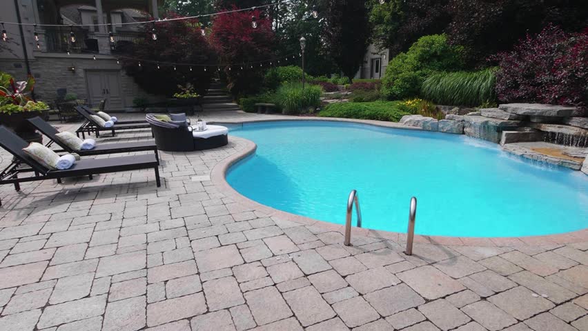 Capture the essence of outdoor luxury with this 4K video of a stunning pool and backyard oasis. Perfect for real estate, design, and creative projects. High-quality visuals, lush landscaping, modern.
