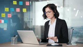 Angry disappointed woman in business attire struggles with faulty laptop while sitting at a workplace in office. Professional person dealing with technology problem while trying to work on computer - Powered by Shutterstock - Get 15% off with code: PIKWIZARD15