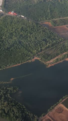 Malaysia - march 05, 2022 - flight in the sky of malaysia and view of large groves around kuala lumpur city from above during flight