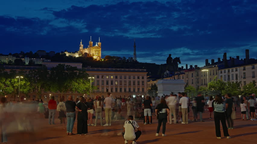 Bastille Day celebration in France. The main holiday of France. Fireworks in the sky. Night time lapse at Place Bellecour on the main place in Lyon city center. Famous tourist destination in France