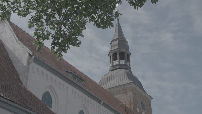 Valmiera, Larvia: ST. SIMONS CHURCH architecture close up shot slowmotion summer sunny day blue sky tree leaves 10bit slog 3