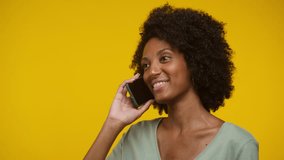 Smiling Woman Talking on Smartphone Against Yellow Background - Powered by Shutterstock - Get 15% off with code: PIKWIZARD15