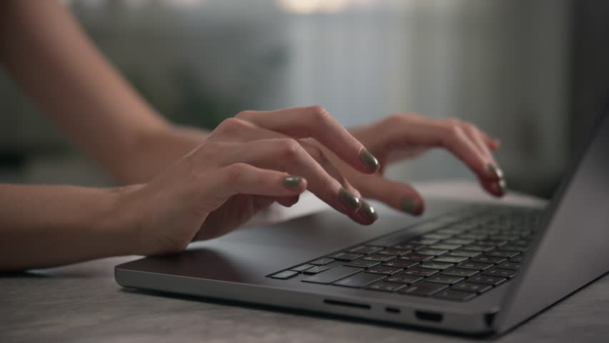Hands Typing on Laptop Keyboard in Calm Indoor Setting