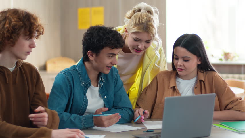 Caucasian four friends students teenagers pupils students teens girls boys guys women men together studying learning at school university college talking discuss task homework preparing exam education