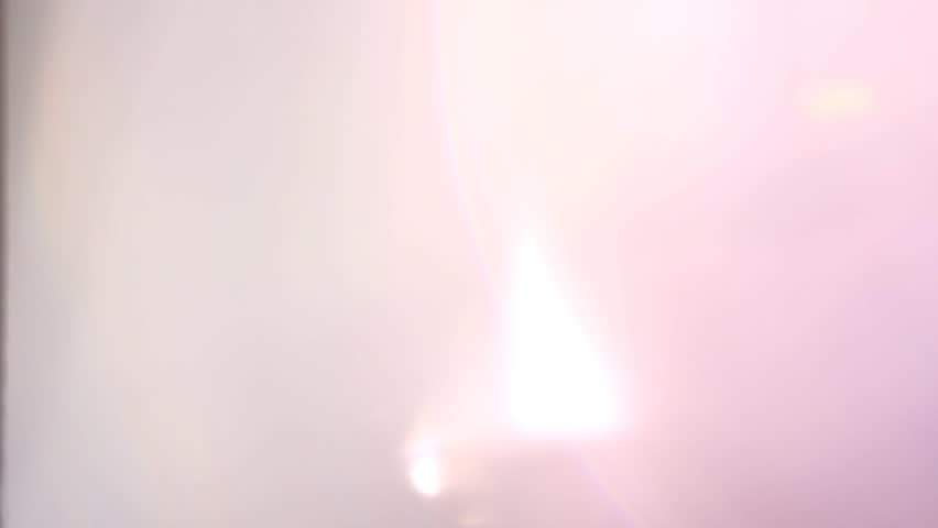 Bright light distortions and fluid transitions, featuring glowing shapes and vibrant colors in a dream-like and abstract visual experience.