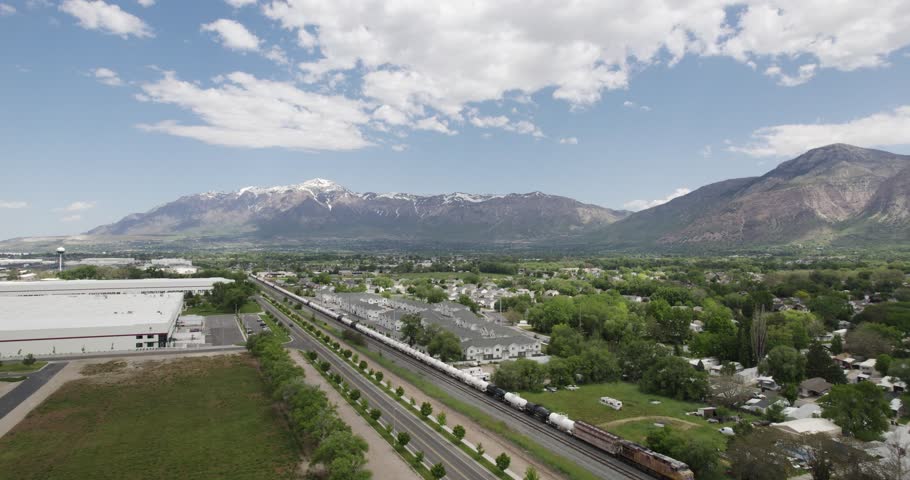 Ogden, utah, showcasing residential areas, distant mountains, and blue sky, aerial view