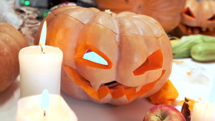 Young woman carving a peeled pumpkin scary jack o