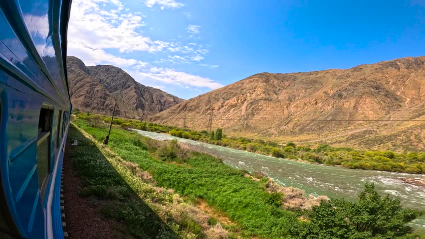 The train passes a mountain river