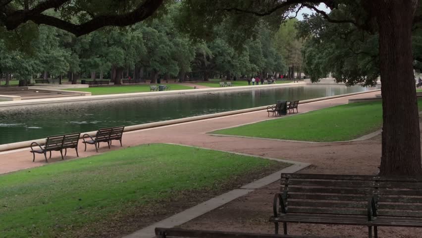 B-roll shot of Reflection Pool with benches in Hermann Park in Houston, TX