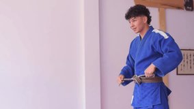 Judo fighter warming up to begin practice in martial arts dojo - Powered by Shutterstock - Get 15% off with code: PIKWIZARD15
