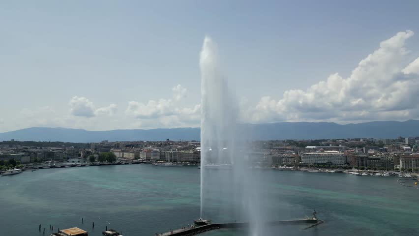 Aerial 4K video of Geneva water fountain on lake Geneva, Switzerland. Drone 360 fly around fountain