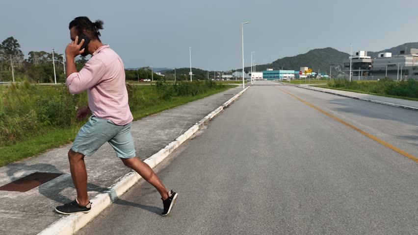Walking and running on neighborhood streets. Cell phone in pocket or hands. Aerial view. Camera following.