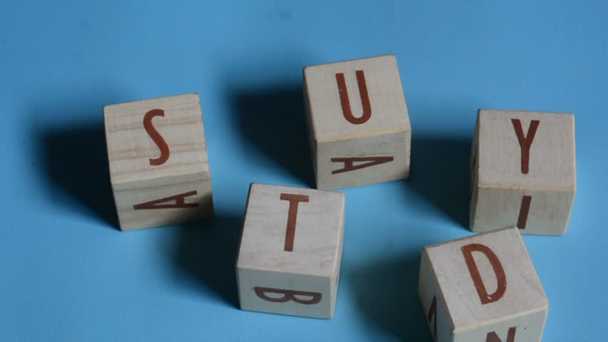 STUDY word written on wood block. Content text on wooden table for your desing, concept.