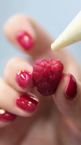raspberries with cream Yogurt Pouring from Top over a Raspberry on Pink Background in Slow Motion and Macro