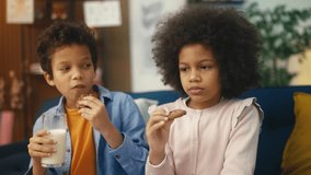 Cute African American siblings drinking milk and eating cookies, snack time - Powered by Shutterstock - Get 15% off with code: PIKWIZARD15