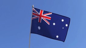 The Australian flag waving in the wind in the blue sky - Powered by Shutterstock - Get 15% off with code: PIKWIZARD15