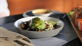 Person enjoying poke with avocado and quinoa in restaurant trendy healthy eating close-up. Gourmet delight person savoring poke with avocado and quinoa high-quality ingredients modern restaurant. - Powered by Shutterstock - Get 15% off with code: PIKWIZARD15