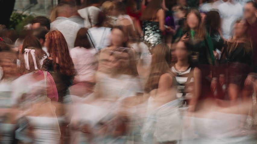 Time-lapse unrecognizable blurry huge crowd of people crossing city street, busy crossroad fast motion, many pedestrians walking crosswalk. Rush hour crowded, people walk, blurred faces and brands