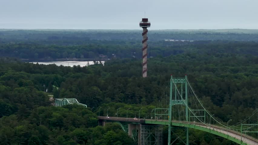 Aerial view of Thousand Islands International Bridge between US and Canada over St. Lawrence River from New York to southeastern Ontario over water and forest in summer