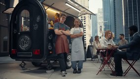 Smiling Male and Female Baristas Standing Confidently in Front of a Coffee Truck, Looking at Camera. Young Colleagues Working in a Busy Street Cafe in a Bustling Urban Neighbourhood - Powered by Shutterstock - Get 15% off with code: PIKWIZARD15