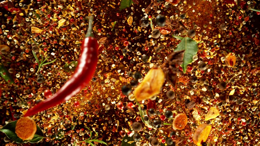 Super Slow Motion of Flying Spice Mix. Isolated on Black Background. Filmed on High Speed Cinema Camera, 1000 fps. Speed Ramp Effect.